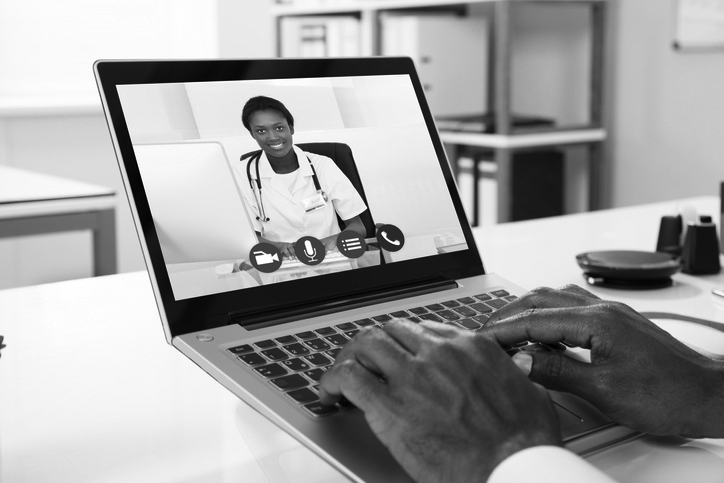 Image of a man using a laptop for a telehealth appointment.